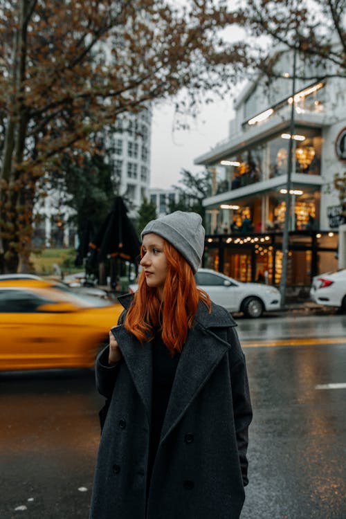 Beautiful Red Haired Woman in Coat on Street