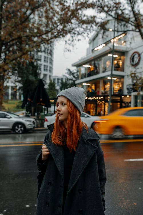 Young Woman Standing in the City Street 