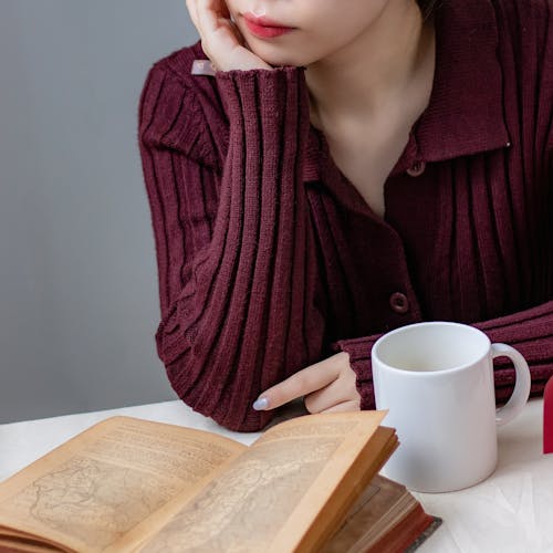 Woman Drinking Coffee and Reading Book 