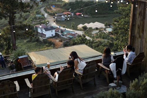 Women Sitting on Terrace over Village