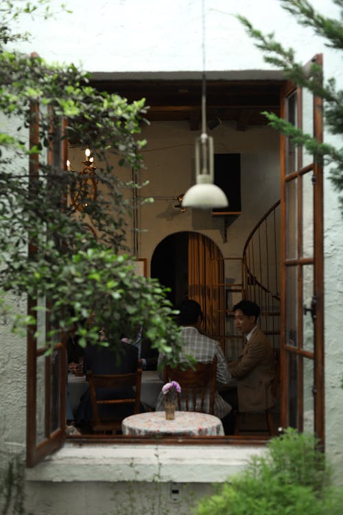 People Sitting behind Cafe Window