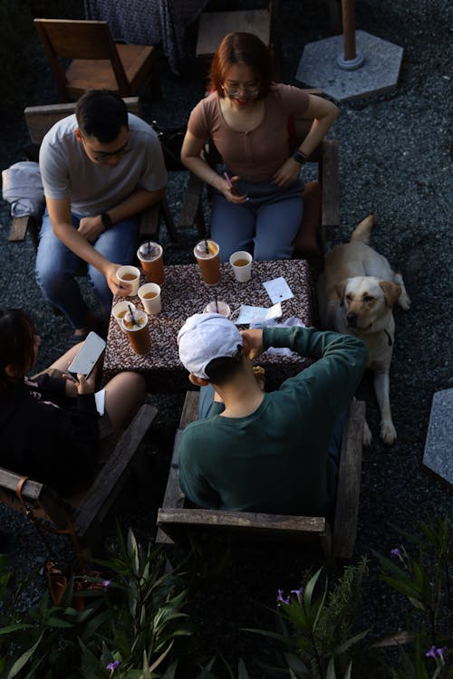 Friends Sitting by Table at Cafe