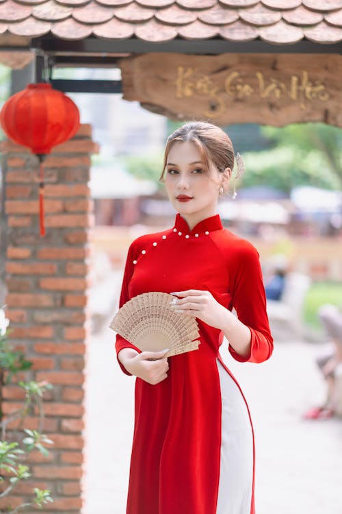 Young Woman in a Traditional Red Vietnamese Ao Dai Dress