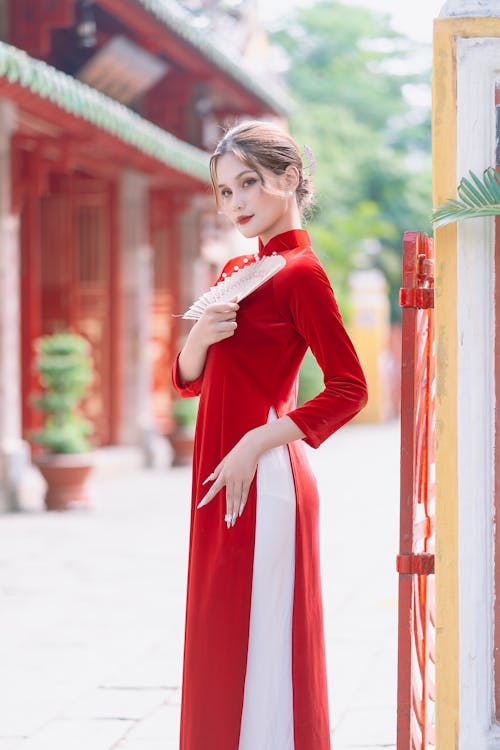 Woman in Red Dress Posing with Hand Fan