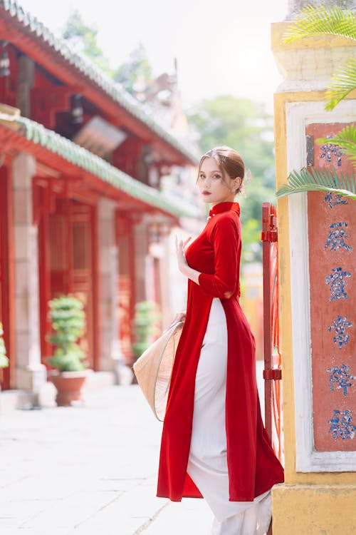 Woman Posing in a Traditional Long Red Dress 