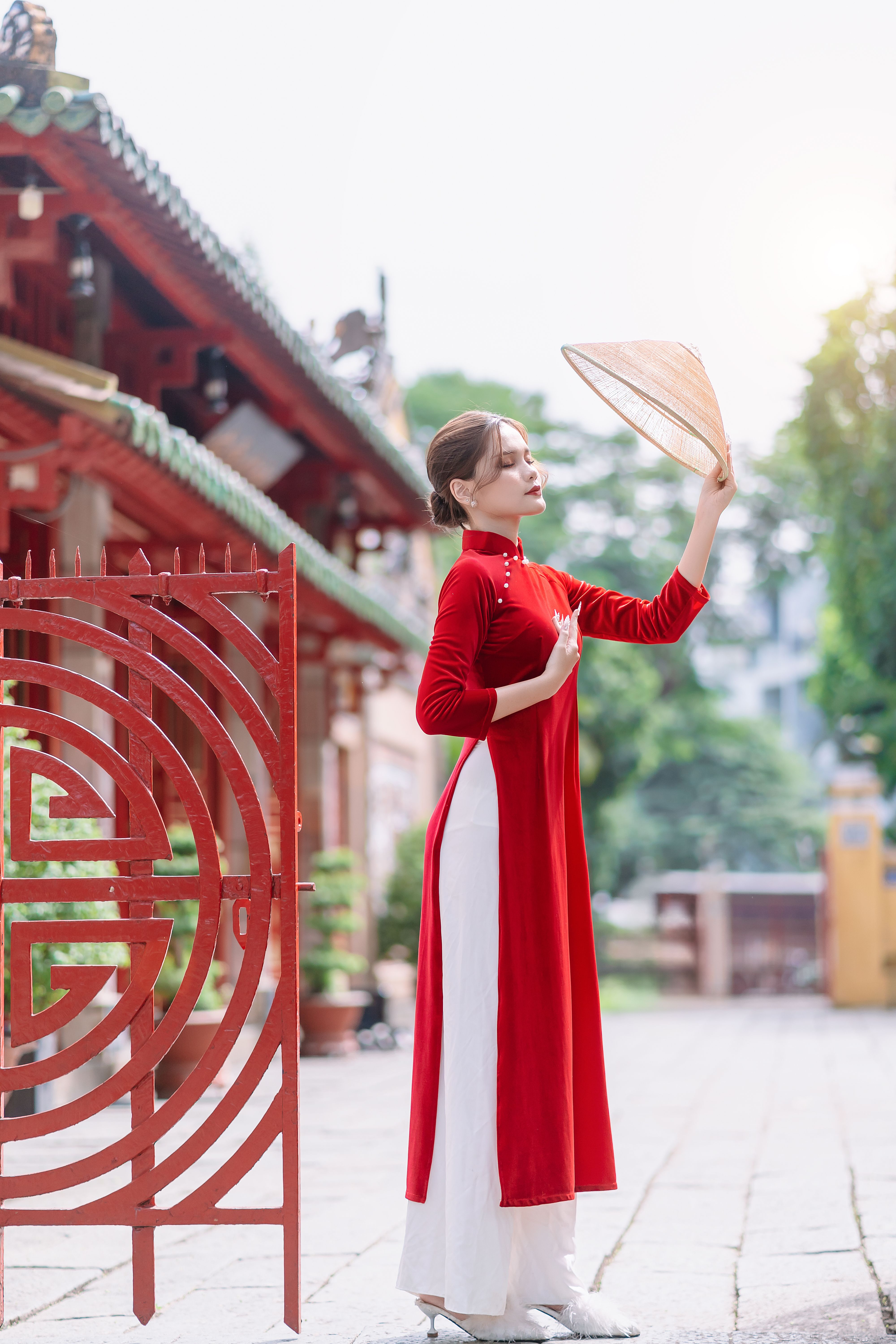 Brunette Woman in Long Red Dress Posing with Hat in Hand · Free Stock Photo
