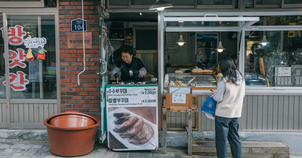 재기를 준비하는 소상공인이 거리의 가게 앞에 서 있는 모습