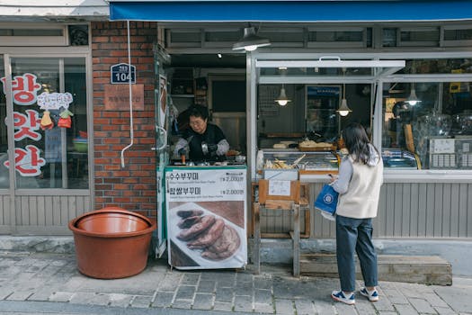 A woman purchasing street food from a vendor in Seoul, capturing urban life.