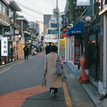 Vibrant street life in a bustling shopping area of Seoul, South Korea, filled with shops and pedestrians.