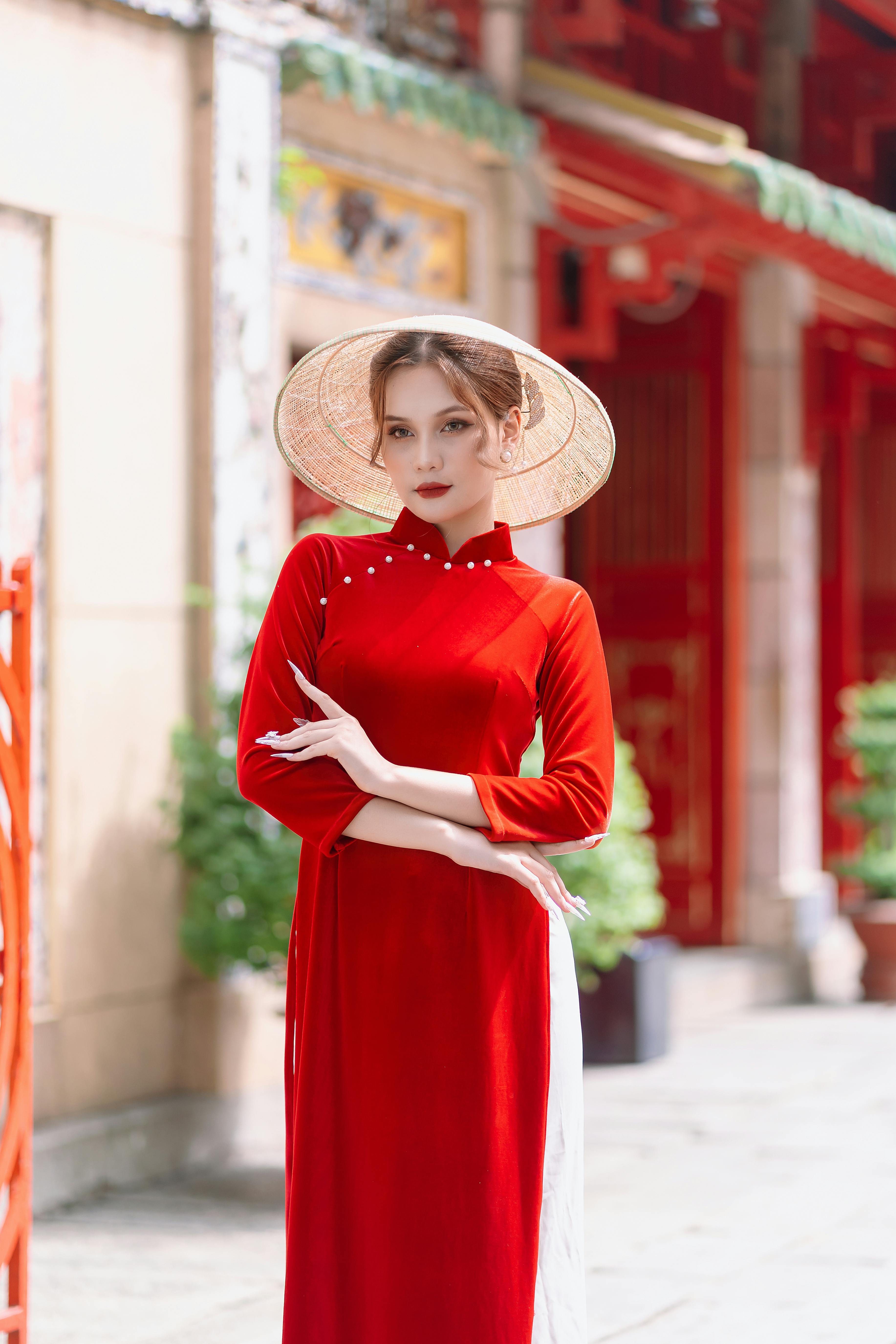 model in conical hat and long red dress