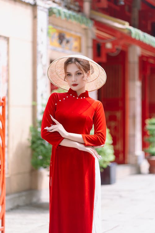 Model in Conical Hat and Long Red Dress