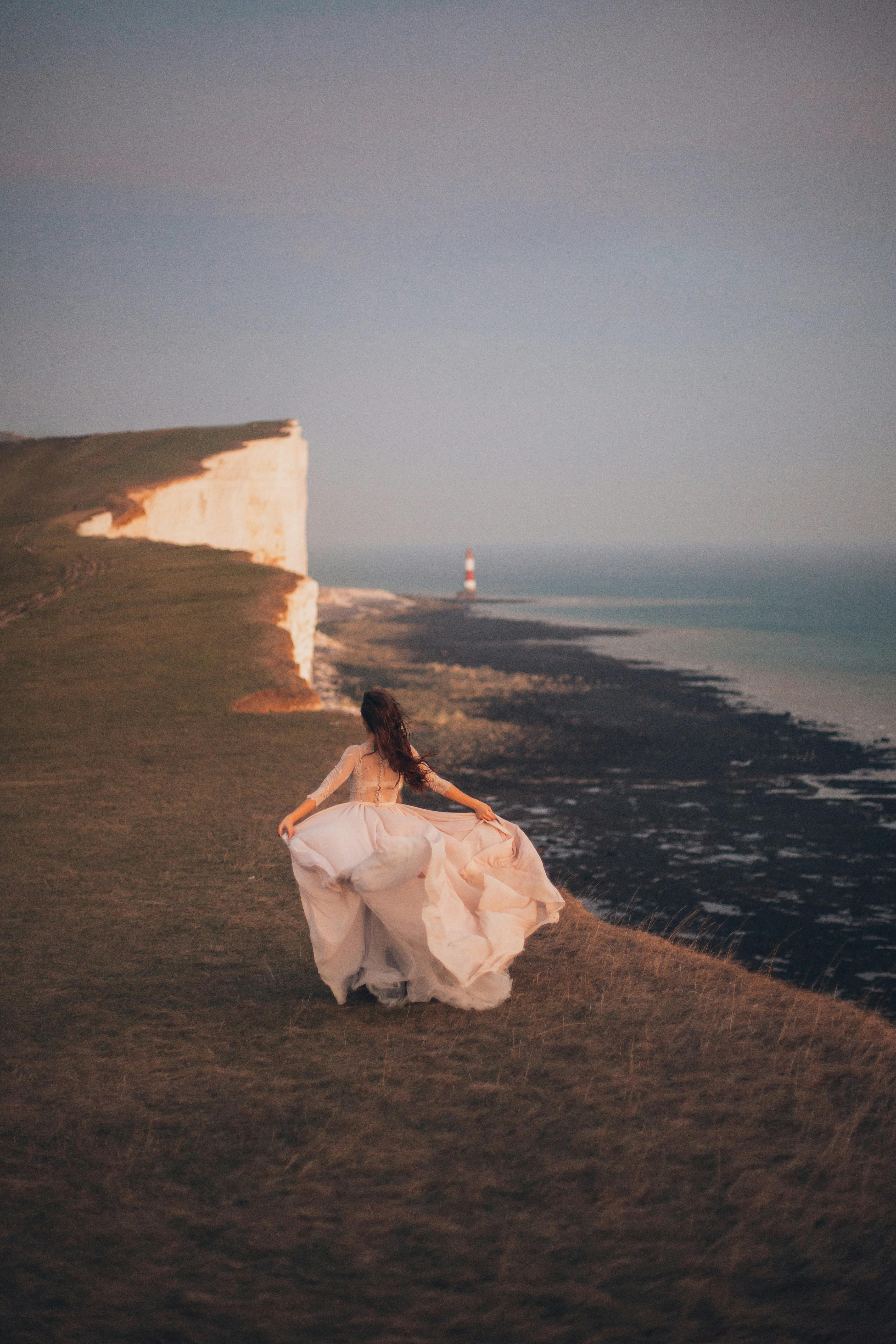 woman walking near body of water