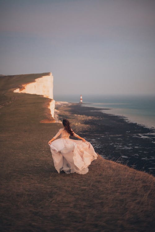 Woman Walking Near Body of Water