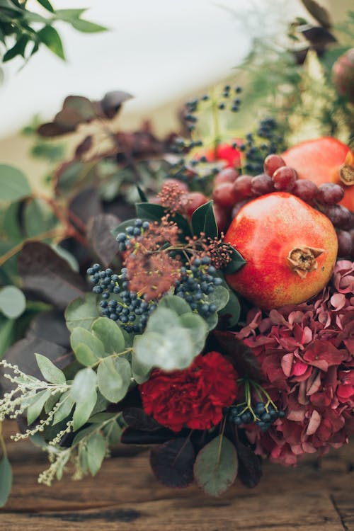 Flowers and Fruits on Wooden Surface