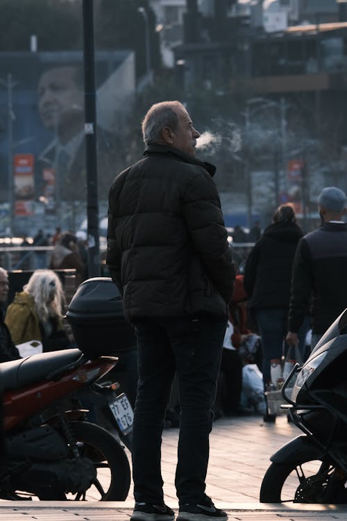 Free Candid Photo of a Man Standing on a Busy Pavement in City  Stock Photo