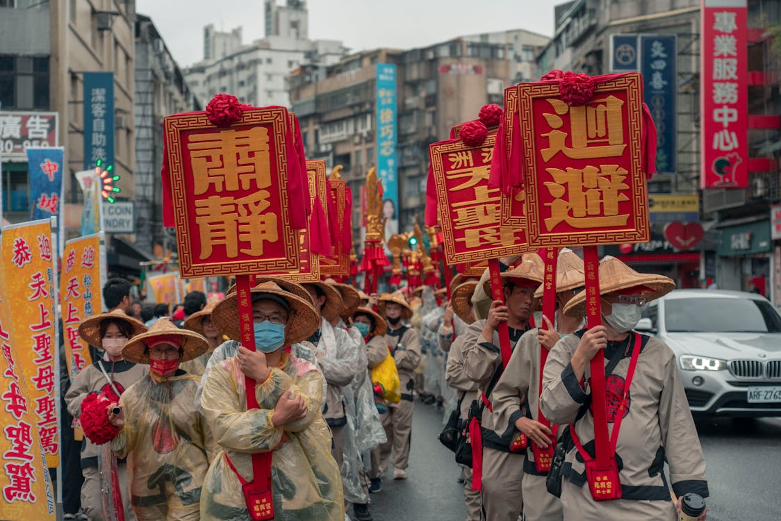 People Walking in a Parade on the City Street during a Celebration 