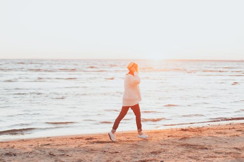 Free Photo of Person Walking On Seashore Stock Photo