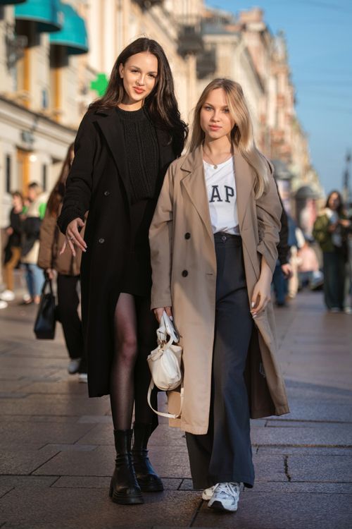 Free Two fashionable women walking on a lively city street, showcasing urban style. Stock Photo