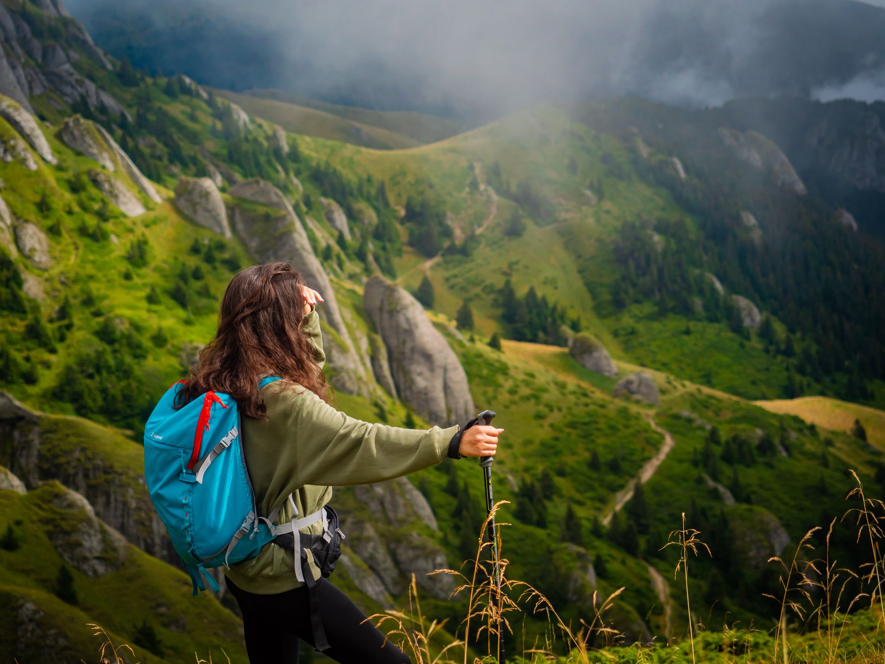 hiker trekking poles mountain trail