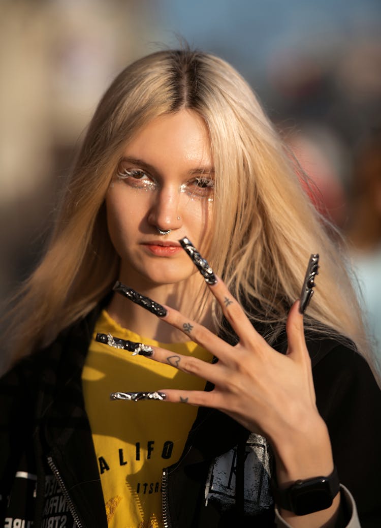 Young Woman With Long Nails Standing Outside 