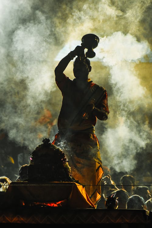A Man Standing in Smoke during a Traditional Ceremony 