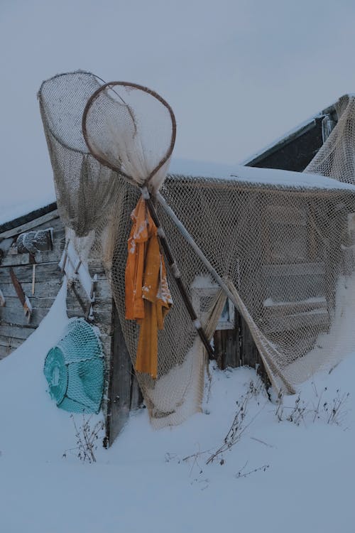Snowed Fisher Shed with Fishing Nets on its Facade