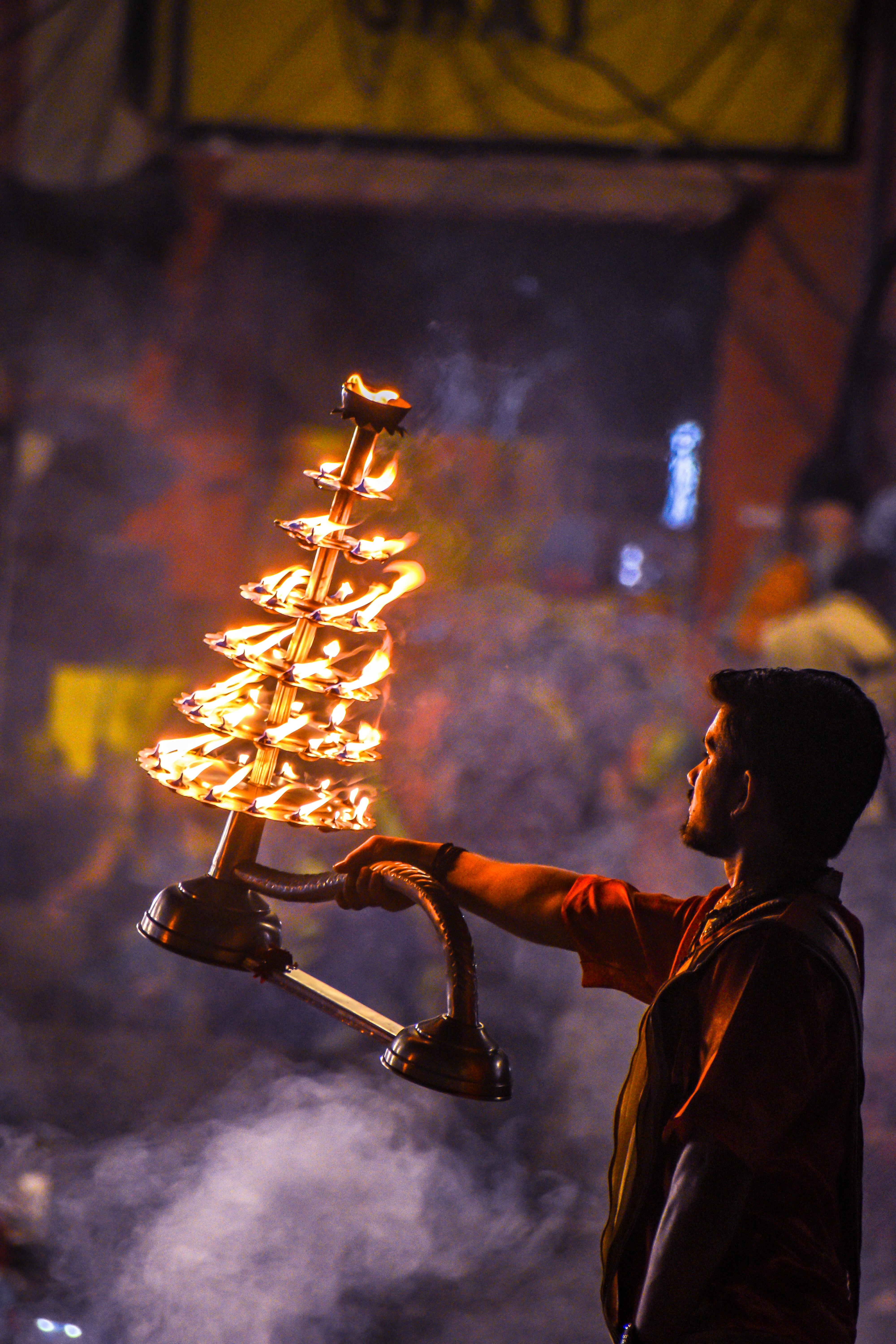 A Man Holding a Stand with Burning Candles during a Traditional ...