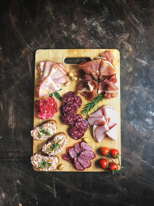 Carnes En Rodajas Sobre Una Tabla De Cortar De Madera