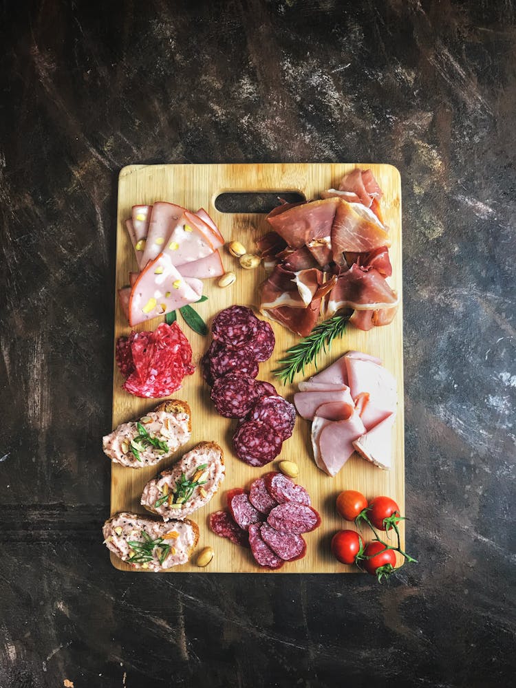 Sliced Meats On Wooden Chopping Board