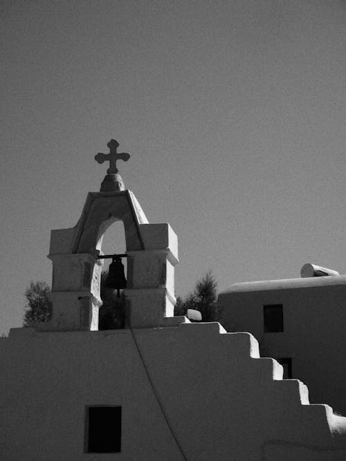 Black and White Photo of a Bell Tower with a Cross 