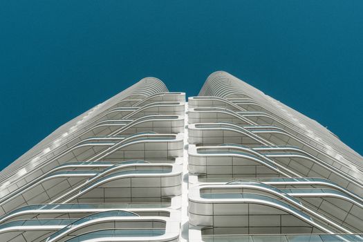 Stunning view of a modern architectural building with sleek glass and steel facade against a clear blue sky.