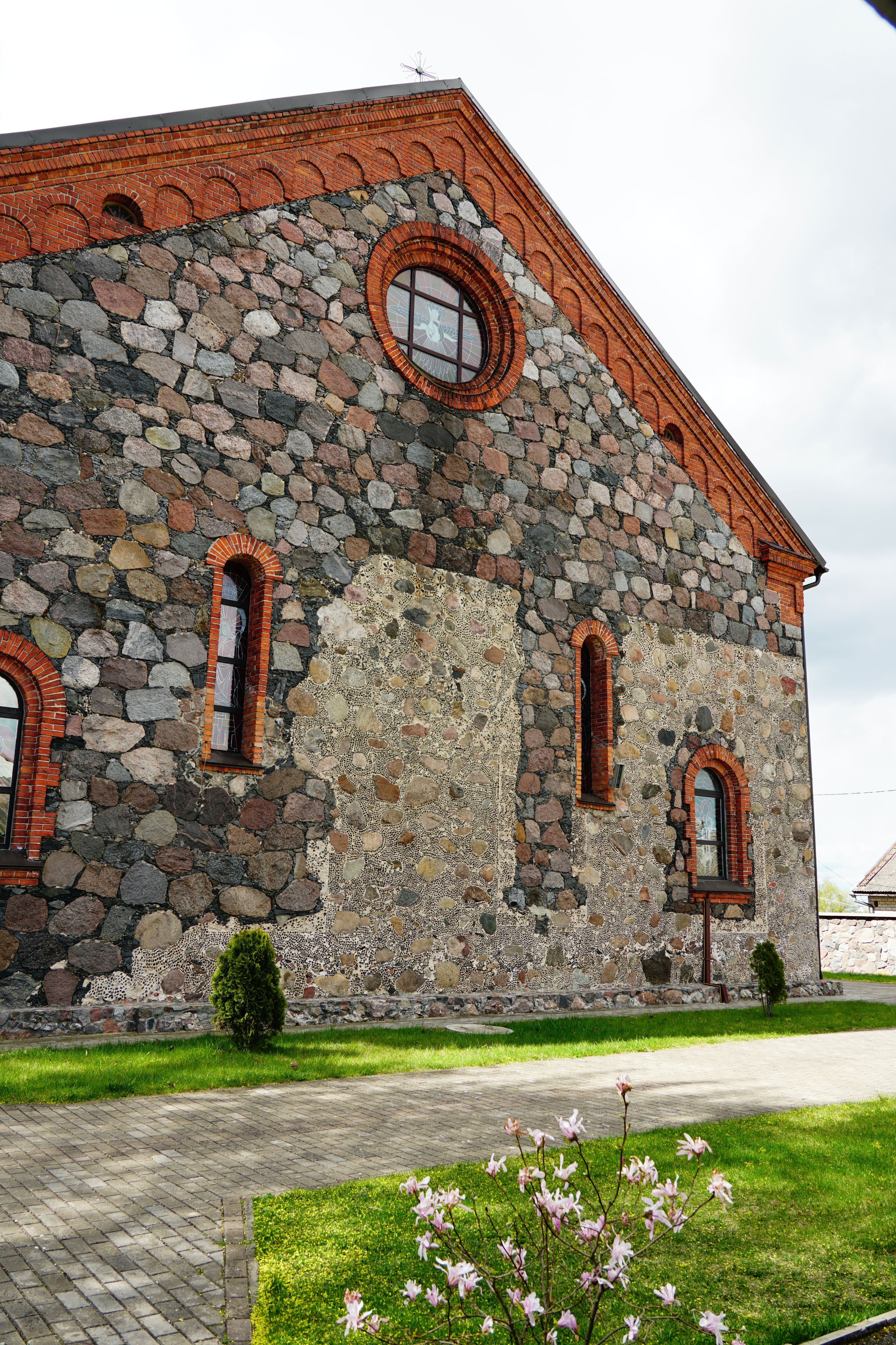 A historic chapel with stone walls and brick detailing, showcasing architectural charm.