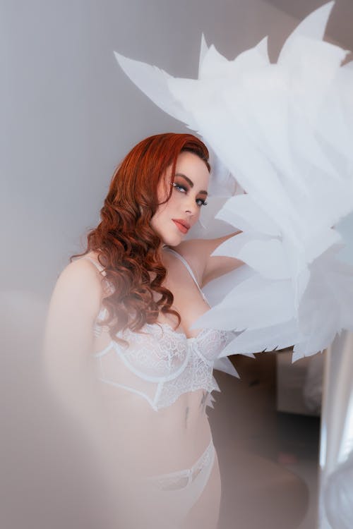 Young Woman Wearing White Lingerie and Angel Wings 