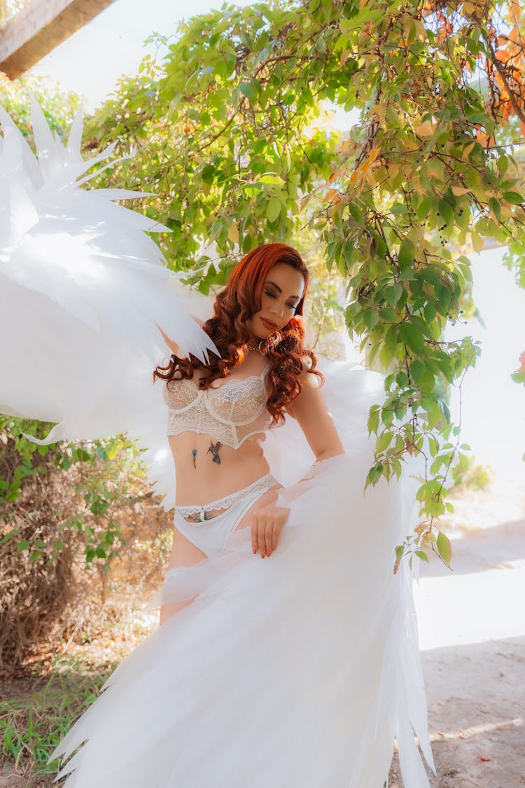 Redhead Model With Wings Posing In Lingerie