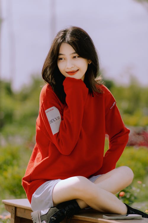 Young Woman in Red Sweater and Shorts