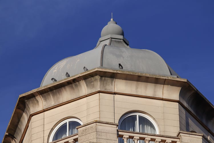 Close-up Of A Building With A Pointy Dome Under Blue Sky 