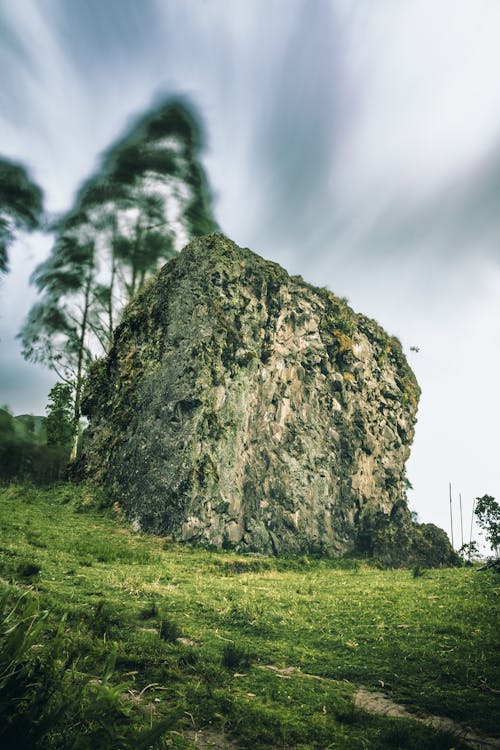 A minimalist rock in a nature place with clouds