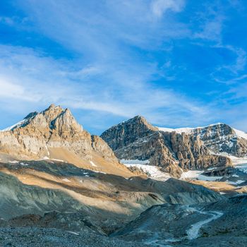 Breathtaking view of the rugged rocky mountains in Banff, Alberta under a clear blue sky.