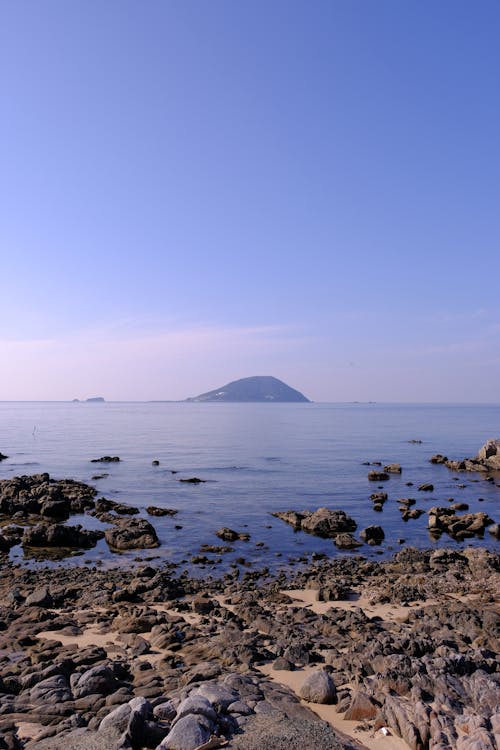 An Island in Distance seen from a Rocky Beach 