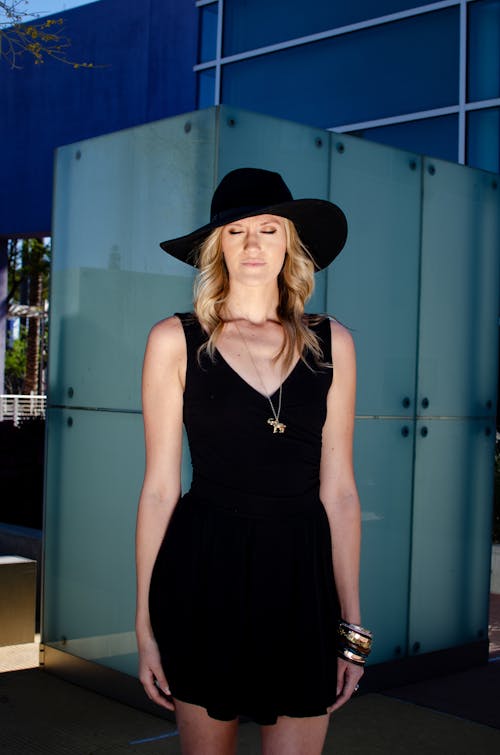Woman Wearing a Black Dress and a Hat 