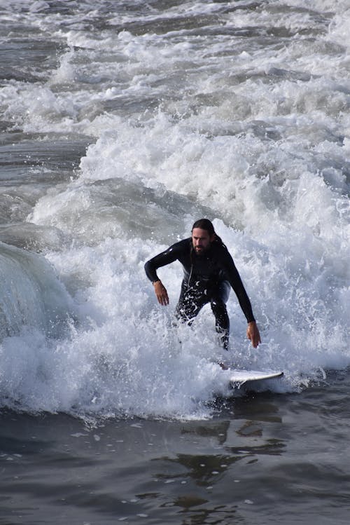 Photo of a Surfer in Foamy Waves 