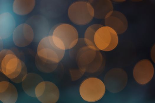 Abstract bokeh background with warm orange circles on a dark backdrop.
