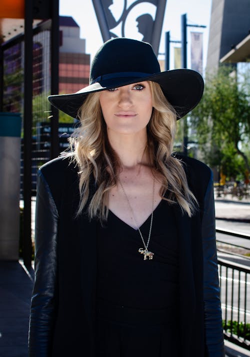 Portrait of Blonde Woman Wearing Black Dress and Hat 