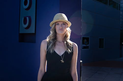Portrait of Blonde Woman Wearing Straw Hat and Black Dress 