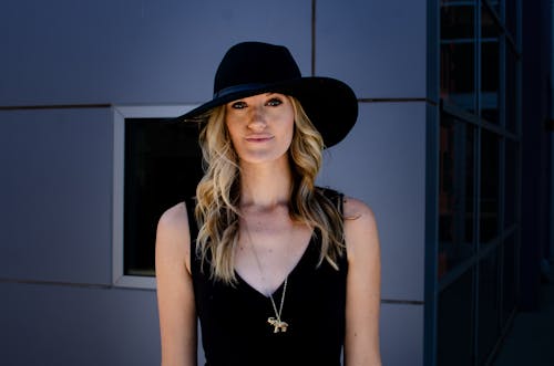 Blonde Woman Wearing a Black Hat 