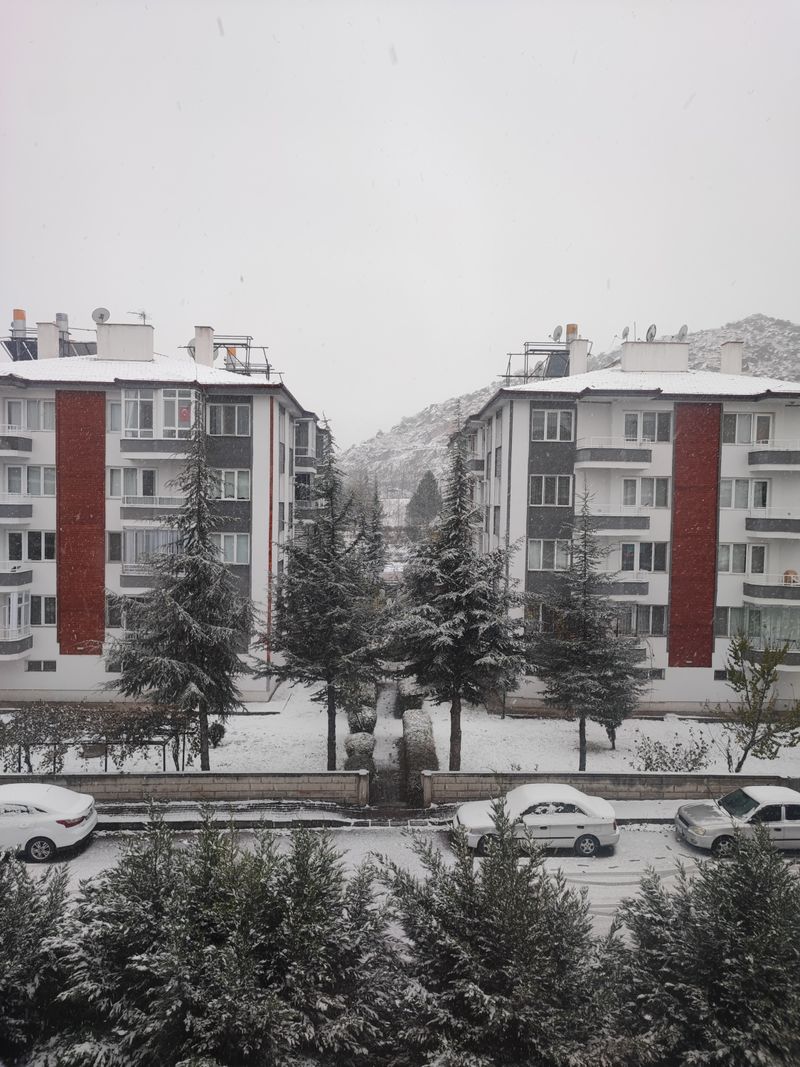 Snow-covered residential and commercial buildings in winter urban setting requiring insulated water storage