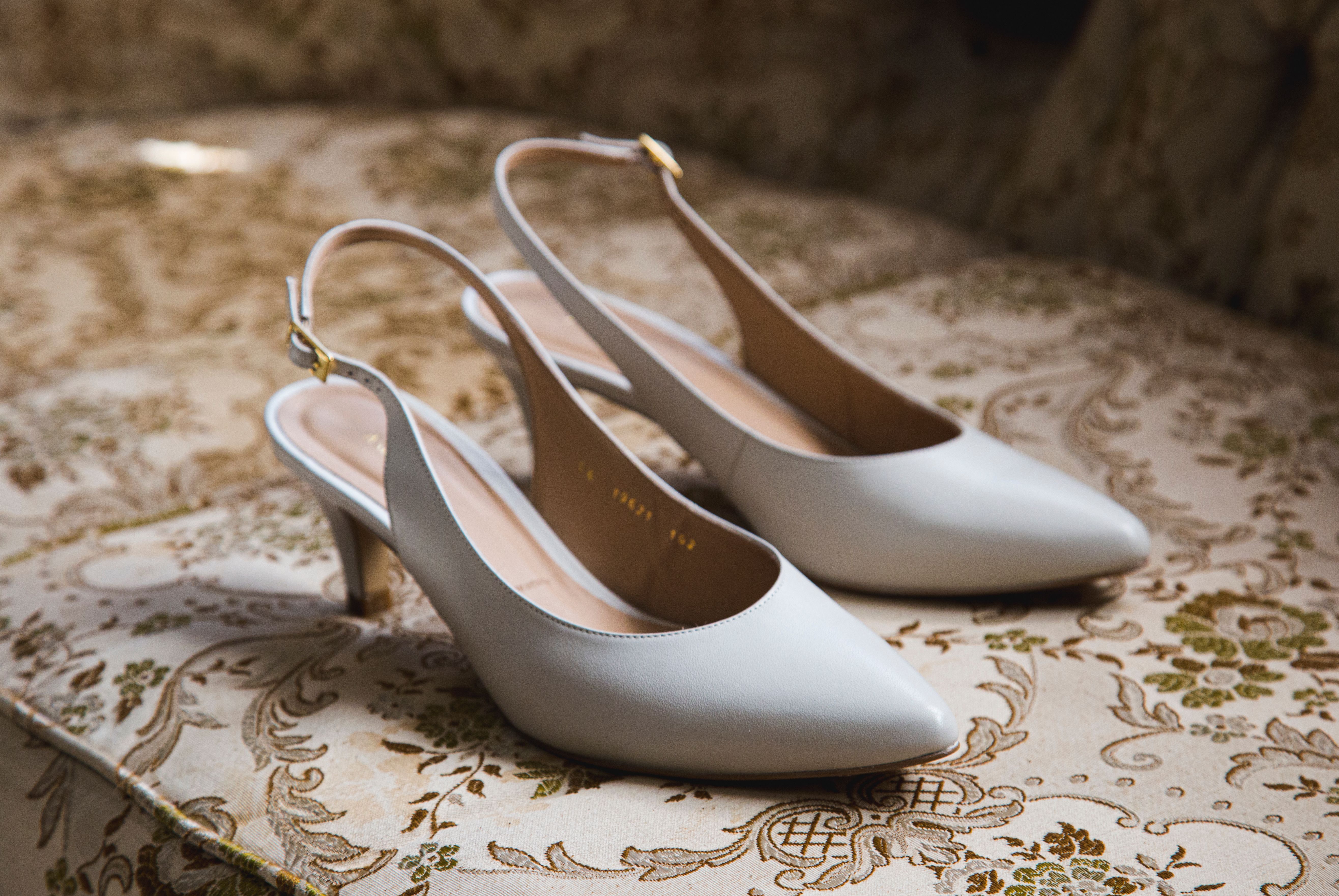 White high heels on vintage upholstery