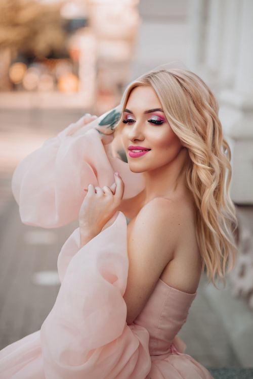 Free Chic portrait of blonde woman in pink gown, embodying elegance and fashion in Strasbourg. Stock Photo