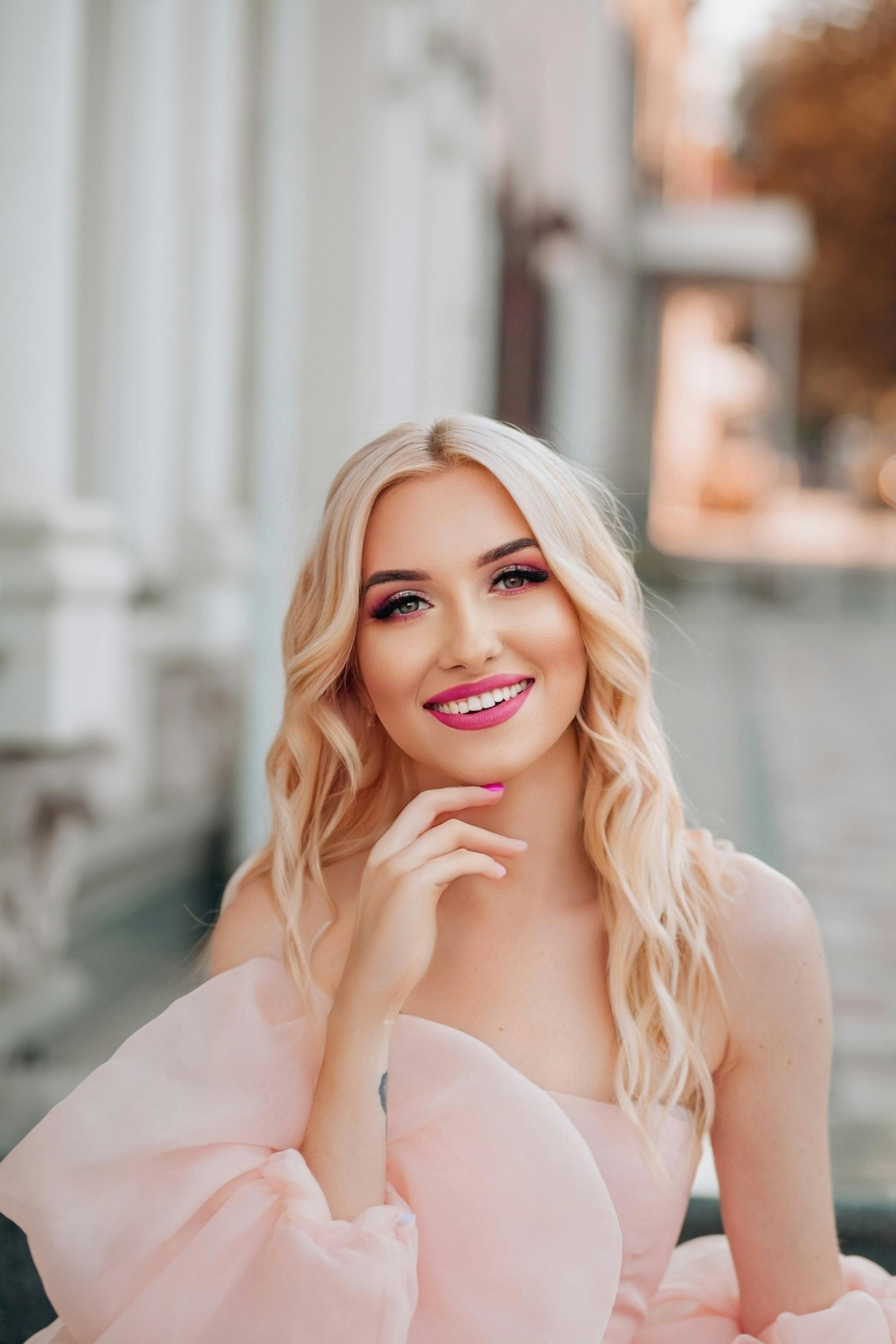 a beautiful blonde woman in a pink dress