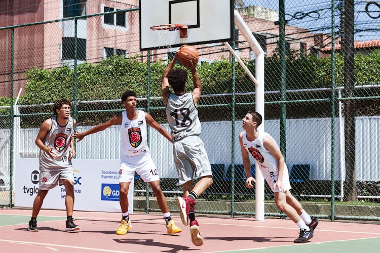 Group Of Young Men Playing Basketball